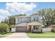 Charming two-story home featuring a brick driveway, attached garage, and well-manicured landscaping with green grass at 1436 Stetson St, Orlando, FL 32804