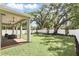 Covered patio featuring outdoor furniture, brick pavers, a ceiling fan, and a view of the spacious, fenced yard at 1436 Stetson St, Orlando, FL 32804