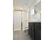 Bathroom featuring glass enclosed shower, dark wood vanity, with modern fixtures and neutral tile flooring at 1672 Tropical Palms Cir, Kissimmee, FL 34747