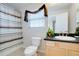 Bright bathroom featuring vanity sink, toilet, and shower with blue and brown curtain at 2173 Victoria Dr, Davenport, FL 33837