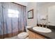 Well-maintained bathroom with a vanity, toilet, and shower with elegant curtain at 2173 Victoria Dr, Davenport, FL 33837