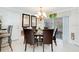 Elegant dining area with chandelier, seating for six, and easy access to the screened lanai at 2173 Victoria Dr, Davenport, FL 33837