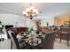 Inviting dining room with elegant chandelier and seating, open to the living area for easy entertaining at 2173 Victoria Dr, Davenport, FL 33837