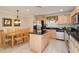 Bright kitchen featuring an island, stainless steel appliances, and wooden cabinets at 2173 Victoria Dr, Davenport, FL 33837