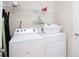 Convenient laundry room featuring a washer, dryer, and overhead storage shelf at 2173 Victoria Dr, Davenport, FL 33837