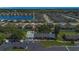 An aerial view of a condominium with parking, landscaping and a nearby pond in a residential community at 2435 King Oak Ln, St Cloud, FL 34769