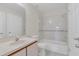 Clean bathroom featuring a shower/tub combo with handrails and a single sink vanity at 2435 King Oak Ln, St Cloud, FL 34769