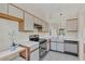 Well-lit kitchen with stainless steel appliances and an adjacent dining area with a view to the living space at 2435 King Oak Ln, St Cloud, FL 34769