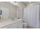 Clean bathroom featuring a well-lit mirror, white cabinets, and a shower with a glass door at 2524 Rapollo Dr, Kissimmee, FL 34741