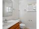 Bright bathroom featuring a single sink vanity, mirror, and a window allowing natural light at 258 Grouper Ct, Kissimmee, FL 34759