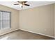 Cozy bedroom featuring neutral walls, carpet flooring, and a ceiling fan at 258 Grouper Ct, Kissimmee, FL 34759