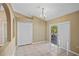 Dining area with tile flooring, sliding glass door to the outside, chandelier, and view through archway at 258 Grouper Ct, Kissimmee, FL 34759