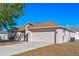 Single-story home with neutral siding, front-facing two-car garage, driveway, and well-maintained lawn at 258 Grouper Ct, Kissimmee, FL 34759