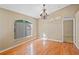 Bright living room featuring light wood flooring, a decorative chandelier, and a large window with natural light at 258 Grouper Ct, Kissimmee, FL 34759