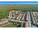 Expansive aerial view of a condo community with multiple buildings, lush landscaping and a pond at 2621 Corvette Lane, Kissimmee, FL 34746