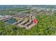 Aerial view of Regal Oaks community featuring townhomes, ponds, lush greenery, and proximity to local attractions at 2621 Corvette Lane, Kissimmee, FL 34746