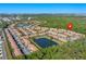 Aerial view of Regal Oaks community featuring townhomes, ponds, lush greenery, and proximity to local attractions at 2621 Corvette Lane, Kissimmee, FL 34746