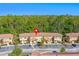 Aerial shot of well-maintained condo complex with ample parking surrounded by lush trees at 2621 Corvette Lane, Kissimmee, FL 34746