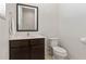Neat half bathroom with modern fixtures and dark wood vanity cabinet at 2621 Corvette Lane, Kissimmee, FL 34746