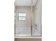 Bathroom featuring a tub and shower combination with a clear glass enclosure and window at 2621 Corvette Lane, Kissimmee, FL 34746