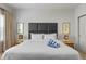 Bright bedroom features a king bed, modern headboard, and stylish bedside tables at 2621 Corvette Lane, Kissimmee, FL 34746