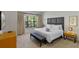Comfortable bedroom with a king bed, soft linens, and a bench at the foot of the bed at 2621 Corvette Lane, Kissimmee, FL 34746