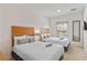 Bedroom featuring two cozy beds, a large window, and a modern flatscreen TV on the wall at 2621 Corvette Lane, Kissimmee, FL 34746