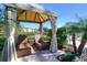 Relax in the cabana with comfortable seating and views of tropical landscaping, offering a private outdoor retreat at 2621 Corvette Lane, Kissimmee, FL 34746
