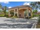 Elegant community entrance with beautiful landscaping and a welcoming gate at 2621 Corvette Lane, Kissimmee, FL 34746