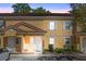 Charming two-story townhouse with a terra cotta tile roof and light yellow exterior at 2621 Corvette Lane, Kissimmee, FL 34746