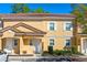 Charming two-story townhouse with a terra cotta tile roof and light yellow exterior at 2621 Corvette Lane, Kissimmee, FL 34746