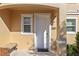 Inviting front entrance with a well-lit, white door and a small adjacent window at 2621 Corvette Lane, Kissimmee, FL 34746