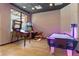 Spacious game room features arcade games, air hockey, and light wood floors at 2621 Corvette Lane, Kissimmee, FL 34746