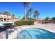View of a resort-style hot tub with palm trees and lounge chairs for community residents at 2621 Corvette Lane, Kissimmee, FL 34746
