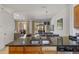 Modern kitchen featuring an island with granite countertops and seamless flow to dining area at 2621 Corvette Lane, Kissimmee, FL 34746