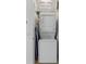 Compact laundry closet with stacked washer and dryer for space-saving convenience at 2621 Corvette Lane, Kissimmee, FL 34746
