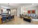 Bright living space with open floor plan, seamlessly connects kitchen, dining, and seating areas at 2621 Corvette Lane, Kissimmee, FL 34746