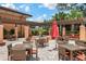 Enjoy the outdoors in the trellis-covered seating area with ample tables, chairs, and a charming center fountain at 2621 Corvette Lane, Kissimmee, FL 34746