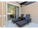 Cozy screened patio featuring lounge chairs, providing a comfortable outdoor space for relaxation at 2621 Corvette Lane, Kissimmee, FL 34746