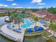Aerial view of resort-style pool with sun deck, palm trees, and cabanas for community residents at 2621 Corvette Lane, Kissimmee, FL 34746