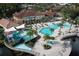 Aerial view showcasing the large resort-style pool with a waterslide and lounge area, perfect for relaxation and fun at 2621 Corvette Lane, Kissimmee, FL 34746