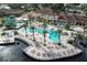 Aerial view showcasing the large resort-style pool with a waterslide and lounge area, perfect for relaxation and fun at 2621 Corvette Lane, Kissimmee, FL 34746