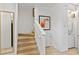Staircase leading to the upper level with a convenient laundry closet at 2621 Corvette Lane, Kissimmee, FL 34746