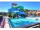 View of resort water slides with an adjacent swimming pool and lounge chairs for community residents at 2621 Corvette Lane, Kissimmee, FL 34746