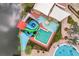 Aerial view of colorful resort water slides with an adjacent swimming pool and sun deck for community residents at 2621 Corvette Lane, Kissimmee, FL 34746