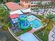 Aerial view of colorful resort water slides with an adjacent swimming pool for community residents at 2621 Corvette Lane, Kissimmee, FL 34746