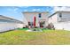 Expansive backyard offering a private retreat with manicured lawn, white fencing, and patio furniture at 2879 Common Crane Ct, Harmony, FL 34773