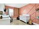 Charming Bedroom featuring a white crib, stylish decor, and a delightful, playful ambiance at 2879 Common Crane Ct, Harmony, FL 34773