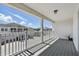 This is a covered balcony featuring white railings and a view of neighboring homes and the blue sky at 2920 Windmill Dr, Kissimmee, FL 34741