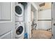 This is a laundry closet with stackable washer and dryer and a shelf at 2920 Windmill Dr, Kissimmee, FL 34741